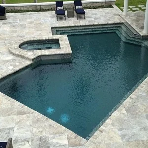 Oyster silver travertine tiles around swimming pool